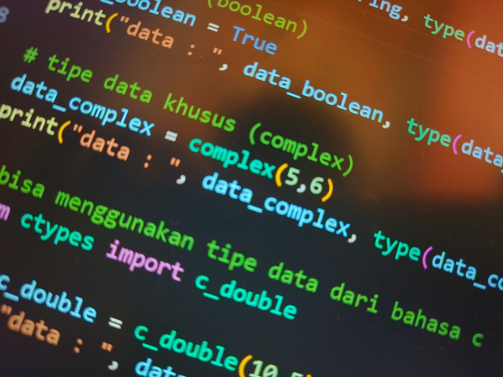 Kleurrijke programmeercode op een beeldscherm, symbool voor de techniek achter AI-illustraties