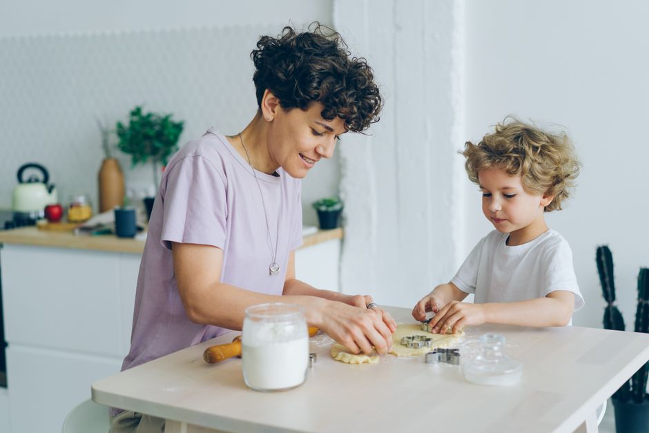 Moeder en zoon bakken samen koekjes in de keuken